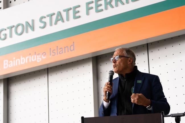 Gov. Jay Inslee speaks at a ferry terminal.
