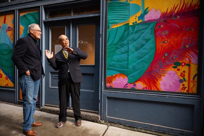 Wing Luke Museum Director Joel Barraquiel Tan and Gov. Jay Inslee view the unveiled healing mural.